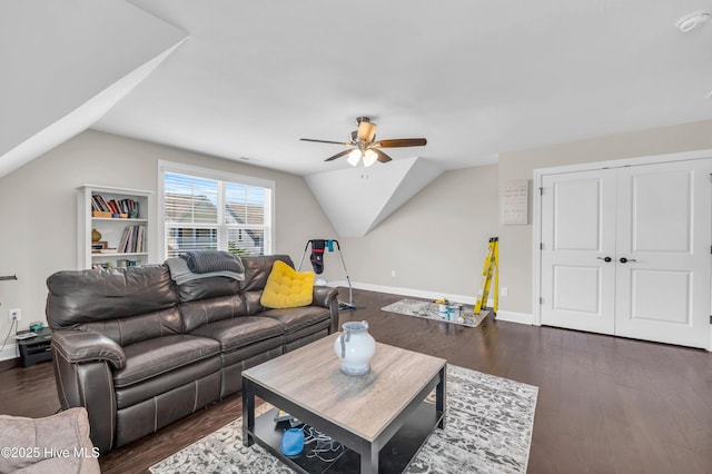 7869 Champlain Dr, Wilmington, NC 28412 - living room featuring ceiling fan, vaulted ceiling, dark wood-style flooring, and baseboards