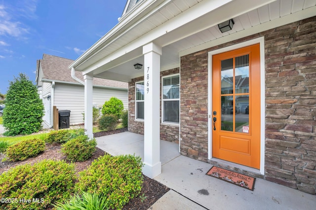 7869 Champlain Dr, Wilmington, NC 28412 - view of exterior entry with covered porch and stone siding