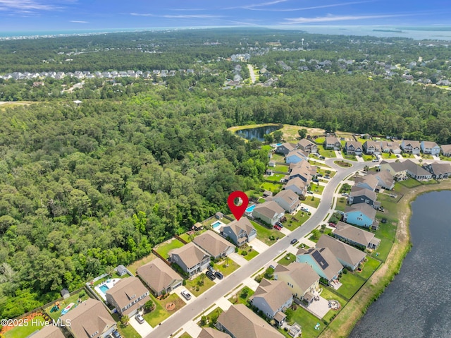 7869 Champlain Dr, Wilmington, NC 28412 - aerial view of property and surrounding area with nearby suburban area, a forest, and a large body of water