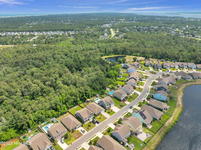 7869 Champlain Dr, Wilmington, NC 28412 - aerial view of property and surrounding area featuring nearby suburban area, a heavily wooded area, and a large body of water