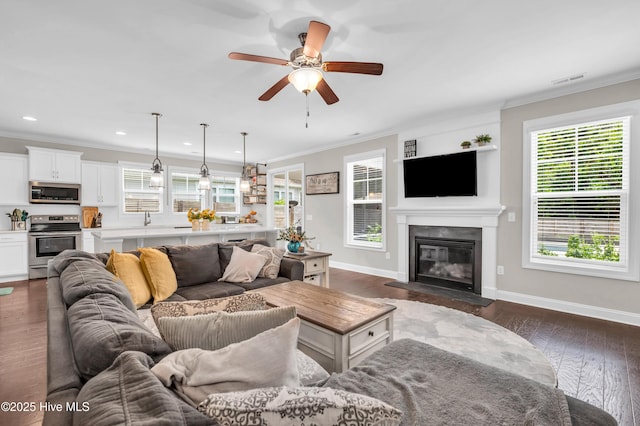 7869 Champlain Dr, Wilmington, NC 28412 - living area with healthy amount of natural light, crown molding, a ceiling fan, and recessed lighting