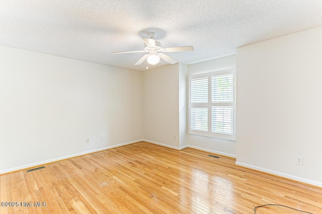 129 Shagbark Ct, West End, NC 27376 - empty room with light wood finished floors, a textured ceiling, a ceiling fan, and baseboards