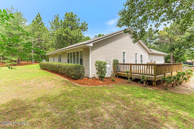 129 Shagbark Ct, West End, NC 27376 - view of home's exterior with a wooden deck and a lawn