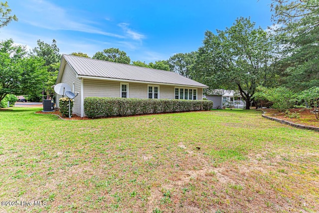 129 Shagbark Ct, Seven Lakes, NC 27376 - rear view of property with a lawn and a metal roof