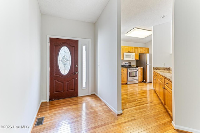 129 Shagbark Ct, West End, NC 27376 - foyer featuring light wood finished floors and baseboards