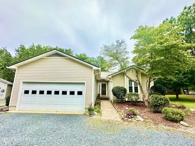 129 Shagbark Ct, Seven Lakes, NC 27376 - ranch-style home with gravel driveway and a garage