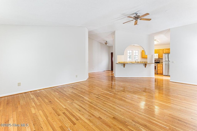 129 Shagbark Ct, West End, NC 27376 - unfurnished living room with light wood finished floors, a ceiling fan, and baseboards