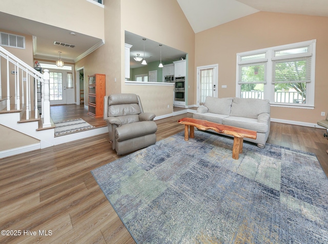 106 Sound Shore Dr, Currituck, NC 27929 - living area featuring wood finished floors, stairs, baseboards, and high vaulted ceiling