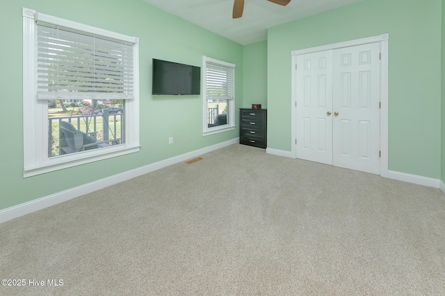 106 Sound Shore Dr, Currituck, NC 27929 - unfurnished bedroom with baseboards, carpet flooring, a closet, and a ceiling fan