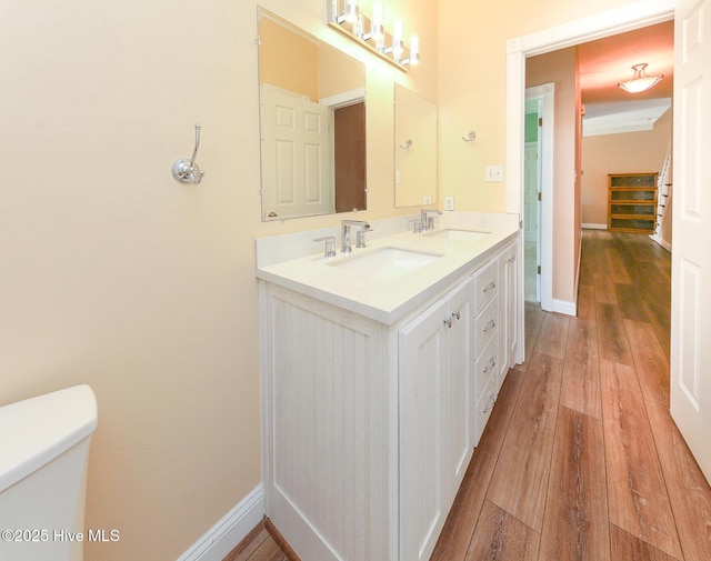 106 Sound Shore Dr, Currituck, NC 27929 - bathroom featuring wood-type flooring, double vanity, toilet, and baseboards