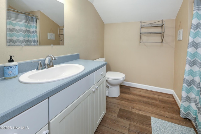 106 Sound Shore Dr, Currituck, NC 27929 - bathroom featuring wood finished floors, vanity, toilet, lofted ceiling, and baseboards