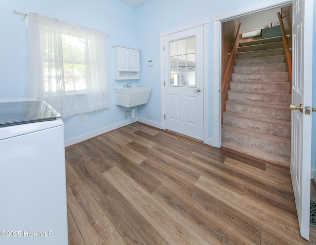 106 Sound Shore Dr, Currituck, NC 27929 - laundry room featuring washer / dryer, wood finished floors, baseboards, and cabinet space
