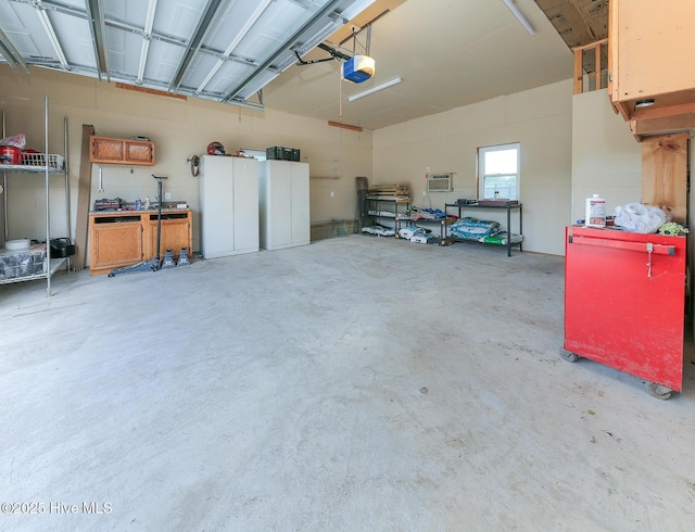 106 Sound Shore Dr, Currituck, NC 27929 - garage featuring a garage door opener and a workshop area