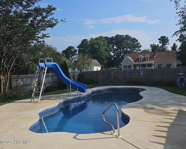 106 Sound Shore Dr, Currituck, NC 27929 - view of pool featuring a water slide, a fenced backyard, and a patio
