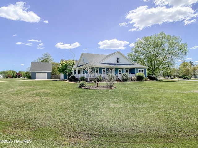 106 Sound Shore Dr, Currituck, NC 27929 - farmhouse-style home with covered porch, a front lawn, and an outbuilding
