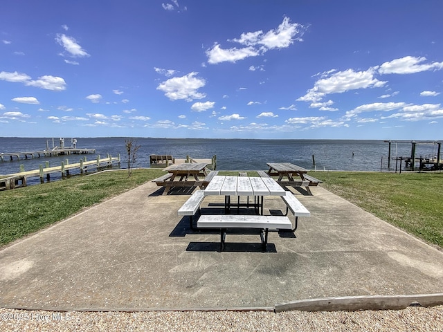 106 Sound Shore Dr, Currituck, NC 27929 - view of patio with a boat dock and a water view