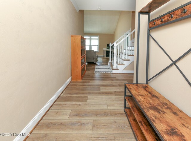 106 Sound Shore Dr, Currituck, NC 27929 - entryway featuring light wood-style flooring, stairway, baseboards, and vaulted ceiling