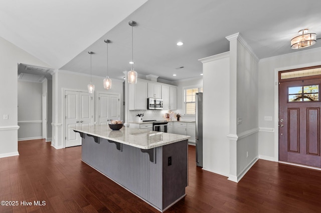 3068 Joe Stocks Rd, Greenville, NC 27858 - kitchen featuring appliances with stainless steel finishes, a breakfast bar, light stone countertops, white cabinetry, and dark wood-type flooring