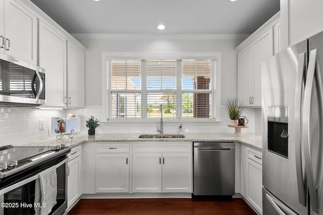 3068 Joe Stocks Rd, Greenville, NC 27858 - kitchen featuring stainless steel appliances, a sink, white cabinetry, crown molding, and tasteful backsplash
