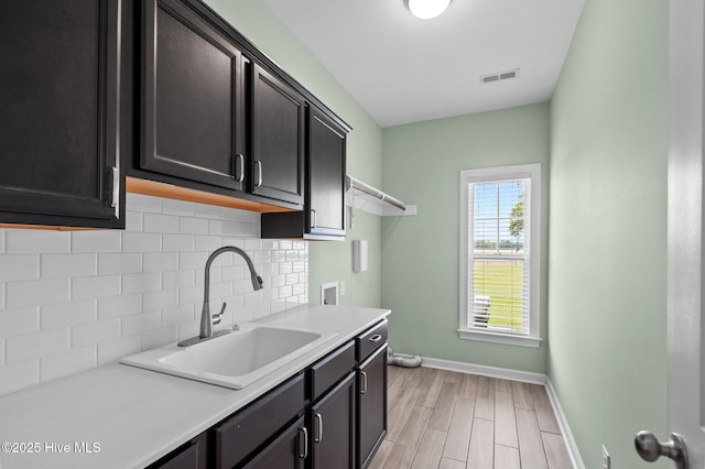 3068 Joe Stocks Rd, Greenville, NC 27858 - washroom featuring cabinet space, baseboards, washer hookup, and light wood-type flooring