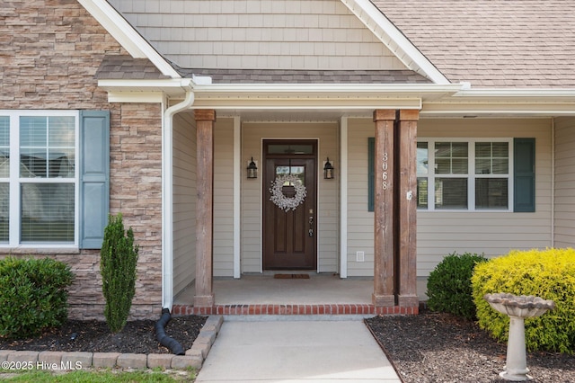 3068 Joe Stocks Rd, Greenville, NC 27858 - entrance to property featuring stone siding, a porch, and roof with shingles