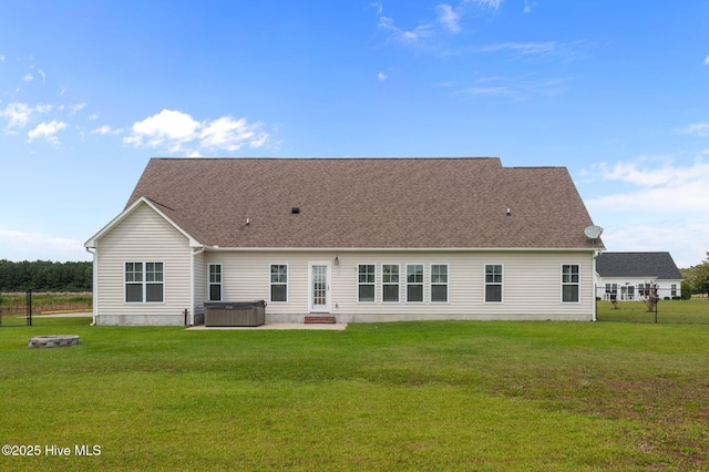 3068 Joe Stocks Rd, Greenville, NC 27858 - rear view of house with a hot tub, a lawn, a patio area, and roof with shingles