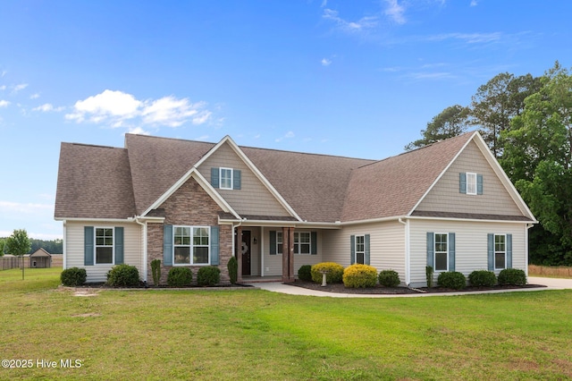 3068 Joe Stocks Rd, Greenville, NC 27858 - view of front of home featuring stone siding, a front yard, a shingled roof, and a porch