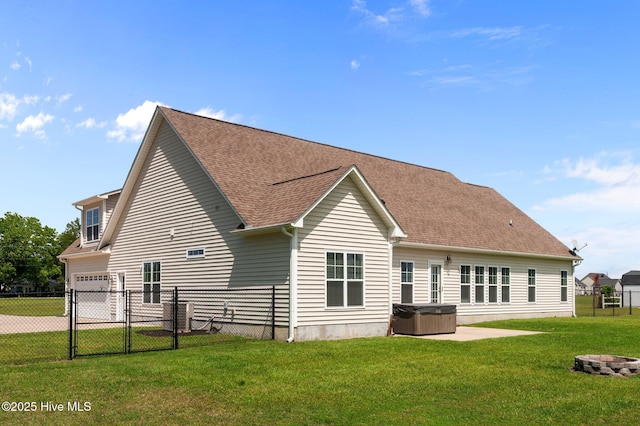 3068 Joe Stocks Rd, Greenville, NC 27858 - back of property with a hot tub, a gate, a shingled roof, an attached garage, and an outdoor fire pit