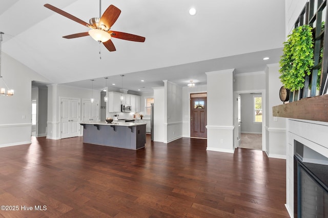 3068 Joe Stocks Rd, Greenville, NC 27858 - living room featuring a fireplace, ceiling fan, dark wood finished floors, recessed lighting, and a chandelier
