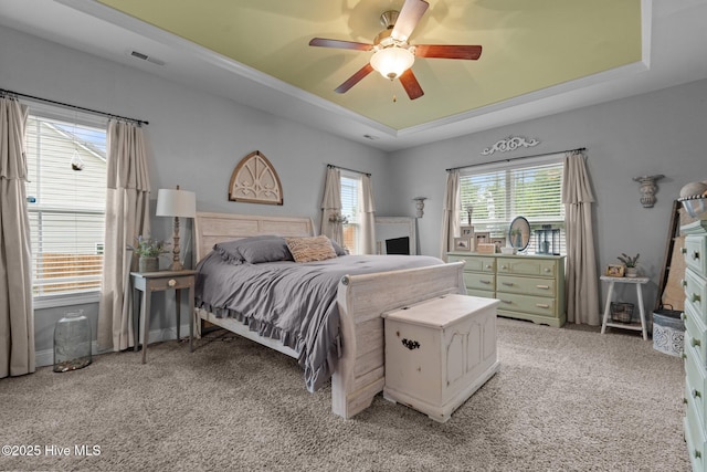 456 N Prince Henry Way, Cameron, NC 28326 - bedroom featuring light colored carpet, a tray ceiling, and a ceiling fan