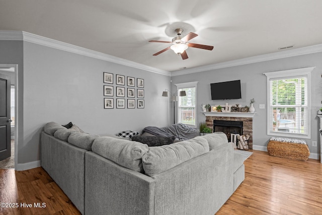 456 N Prince Henry Way, Cameron, NC 28326 - living room with ceiling fan, wood finished floors, a fireplace, plenty of natural light, and ornamental molding