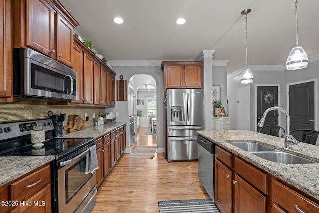 456 N Prince Henry Way, Cameron, NC 28326 - kitchen featuring stainless steel appliances, a sink, ornamental molding, arched walkways, and light wood-style floors