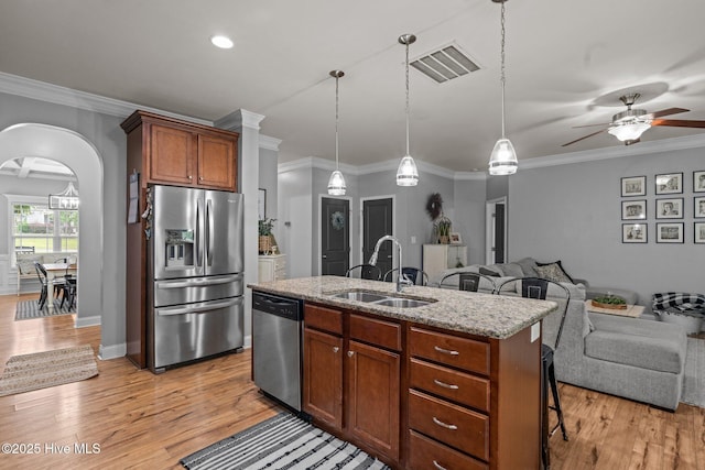 456 N Prince Henry Way, Cameron, NC 28326 - kitchen with appliances with stainless steel finishes, a sink, open floor plan, a ceiling fan, and a breakfast bar area