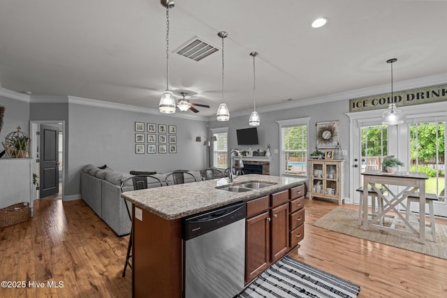 456 N Prince Henry Way, Cameron, NC 28326 - kitchen featuring dishwasher, a sink, light wood-style flooring, ceiling fan, and a fireplace