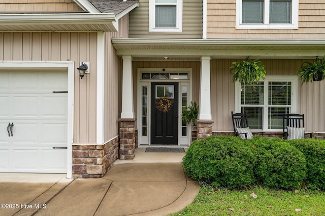 456 N Prince Henry Way, Cameron, NC 28326 - entrance to property featuring stone siding, a porch, and a garage