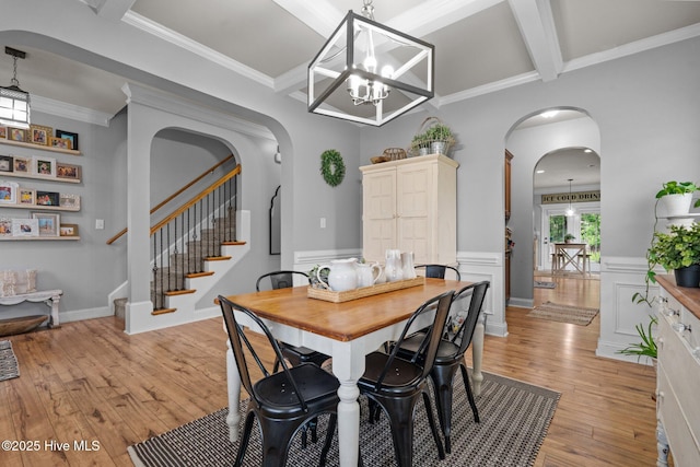 456 N Prince Henry Way, Cameron, NC 28326 - dining room featuring arched walkways, light wood-style flooring, beamed ceiling, stairs, and a chandelier