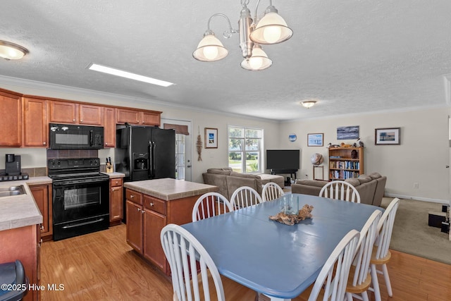233 NE 70th St, Oak Island, NC 28465 - dining space with a textured ceiling, light wood-style floors, and ornamental molding