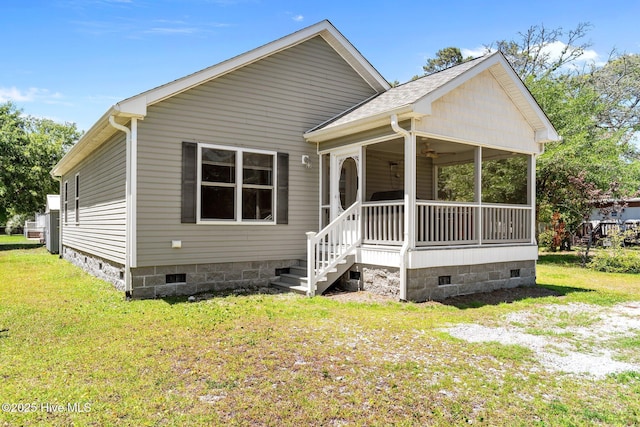 233 NE 70th St, Oak Island, NC 28465 - view of front of house featuring crawl space, a front yard, a ceiling fan, and a porch