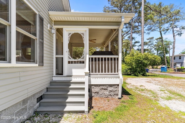 233 NE 70th St, Oak Island, NC 28465 - view of exterior entry featuring a porch and a ceiling fan