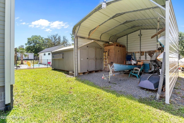 233 NE 70th St, Oak Island, NC 28465 - view of vehicle parking featuring a storage unit and a carport