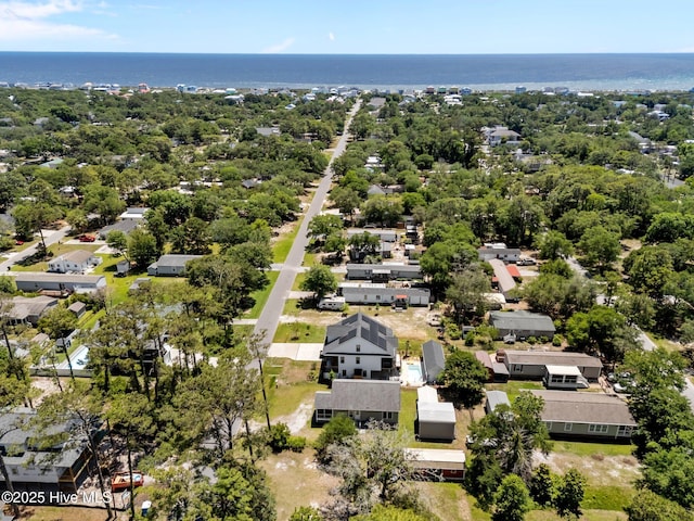 233 NE 70th St, Oak Island, NC 28465 - aerial view of residential area with a large body of water and a tree filled landscape
