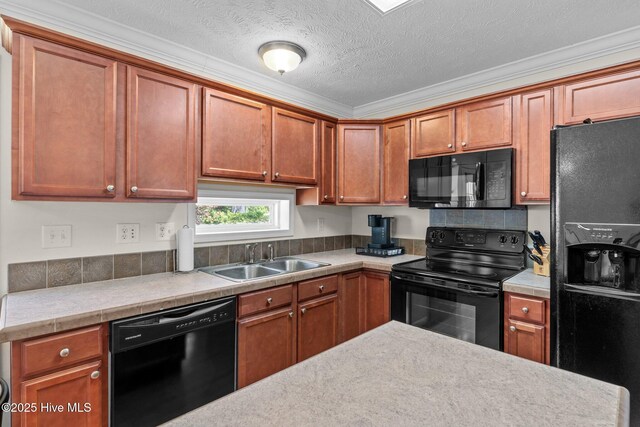 233 NE 70th St, Oak Island, NC 28465 - kitchen with black appliances, a sink, light countertops, ornamental molding, and brown cabinetry