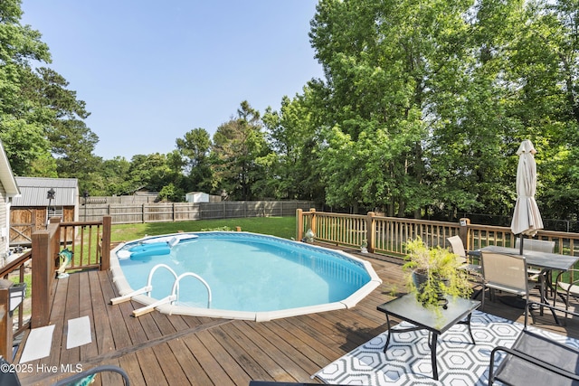 130 Combine Ln, Leland, NC 28451 - view of pool with a deck, view of wooded area, and outdoor dining space