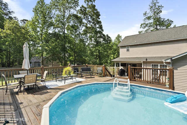 130 Combine Ln, Leland, NC 28451 - swimming pool with a wooden deck and outdoor dining area