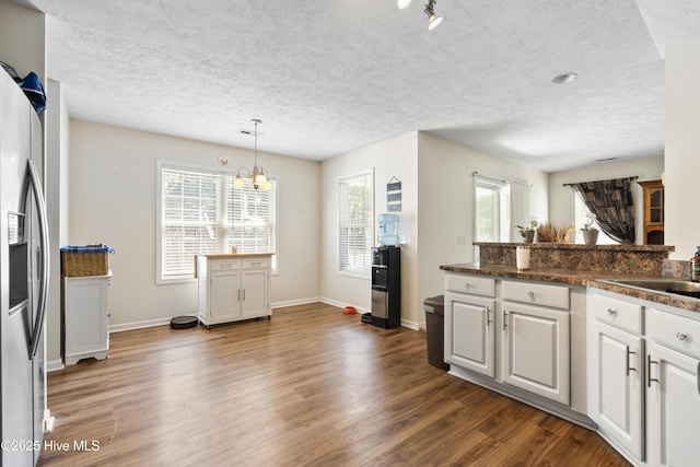130 Combine Ln, Leland, NC 28451 - kitchen featuring stainless steel fridge with ice dispenser, dark wood-type flooring, a chandelier, a sink, and dark countertops