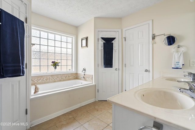 130 Combine Ln, Leland, NC 28451 - full bathroom featuring a garden tub, double vanity, a textured ceiling, and tile patterned flooring