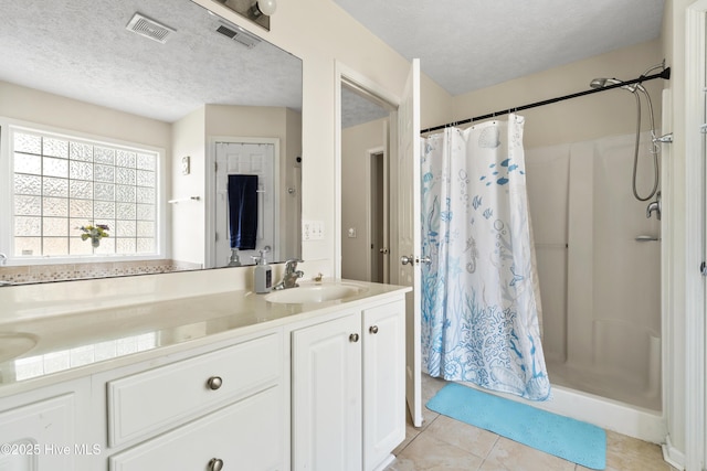 130 Combine Ln, Leland, NC 28451 - bathroom with vanity, a textured ceiling, a stall shower, and tile patterned flooring