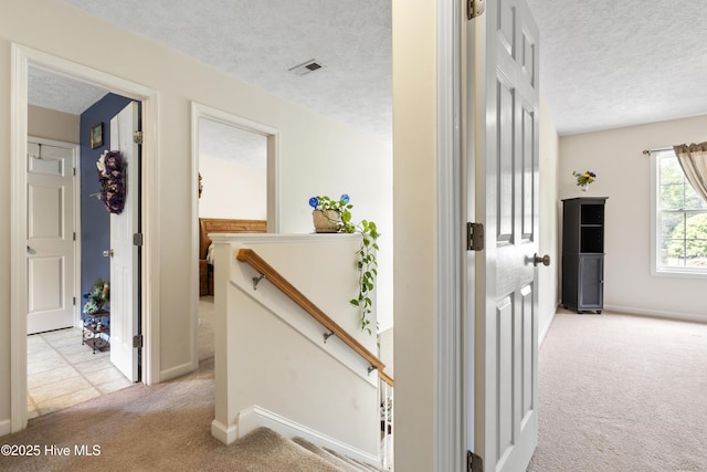 130 Combine Ln, Leland, NC 28451 - hall featuring light colored carpet, a textured ceiling, an upstairs landing, and baseboards