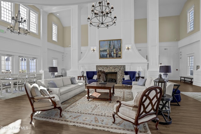 557 Moss Lake Ln, Holly Ridge, NC 28445 - living room with high vaulted ceiling, a chandelier, plenty of natural light, and a decorative wall