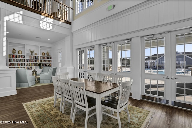 557 Moss Lake Ln, Holly Ridge, NC 28445 - dining room with a high ceiling, healthy amount of natural light, wood finished floors, and crown molding